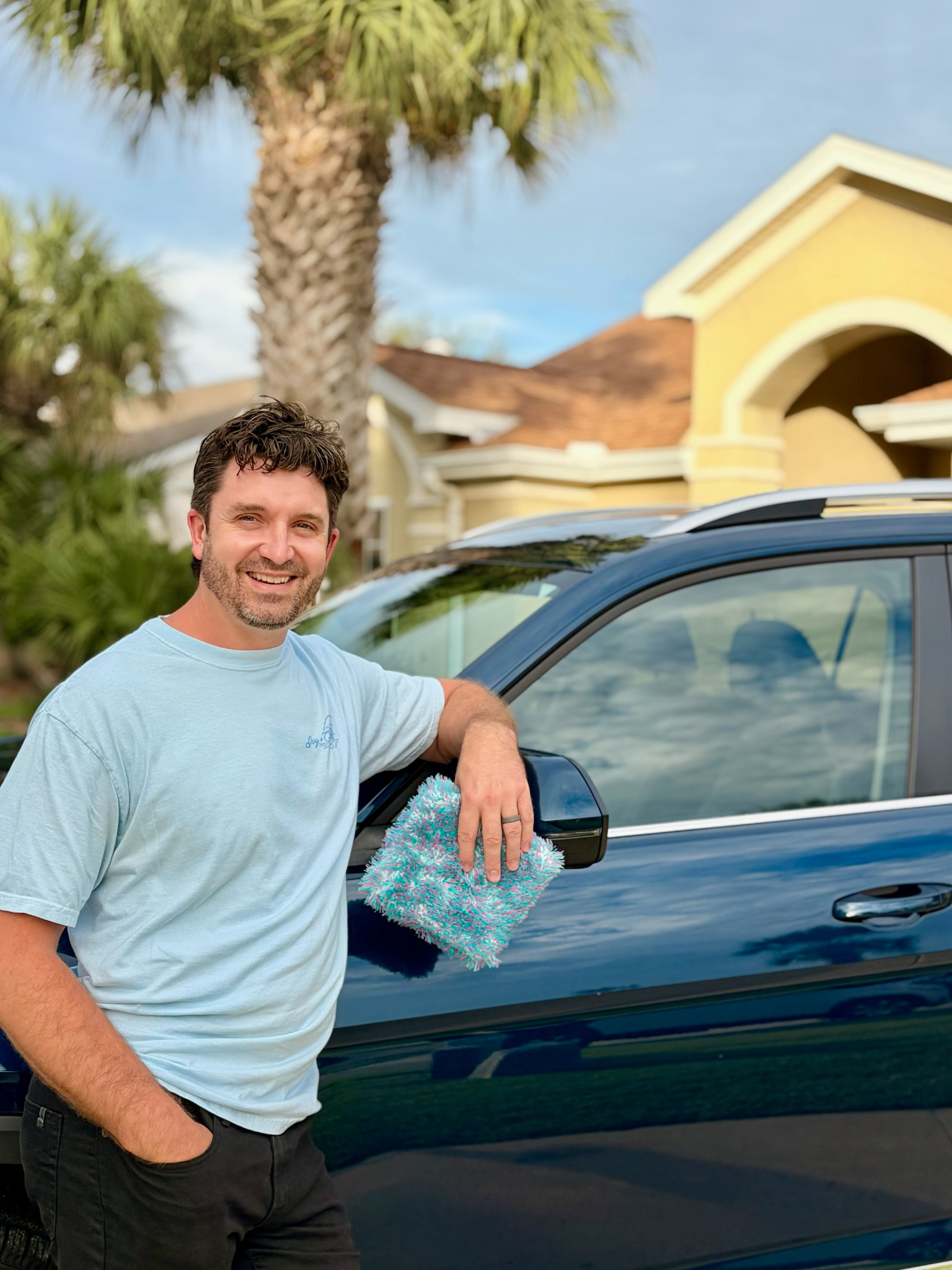 Clint Slocum beside a freshly detailed vehicle in Panama City Beach